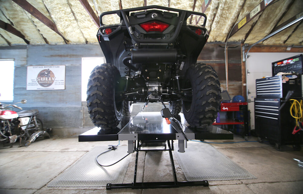 SAM side extensions on lift with UTV in a garage