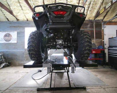 SAM side extensions on lift with UTV in a garage