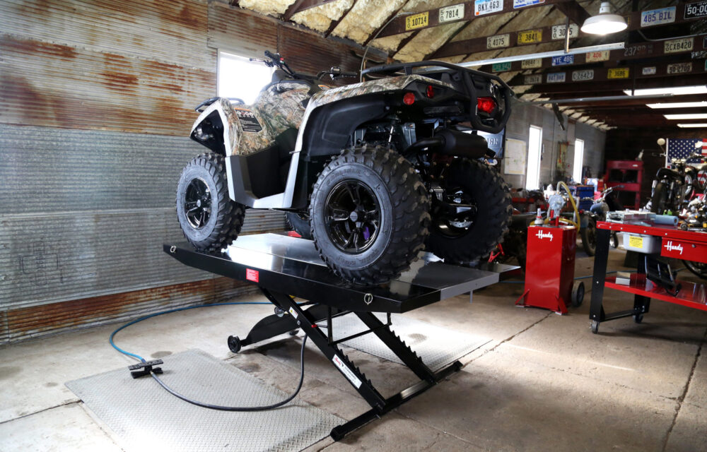 garage with utv on lift with side extenstions